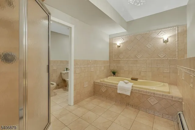 a bathroom with a bathtub and toilet