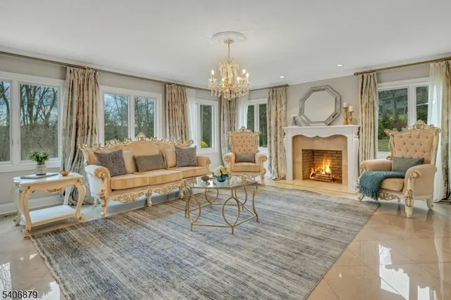 a living room with furniture a large window and a fireplace