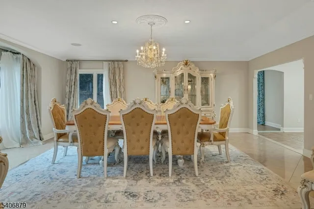a view of a dining room with furniture and chandelier