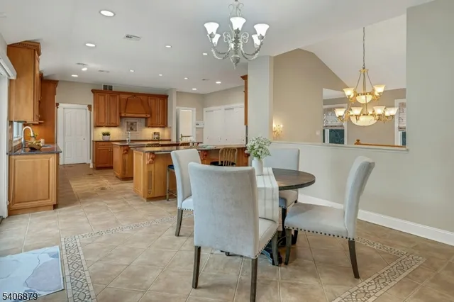 a view of a dining room with furniture and chandelier