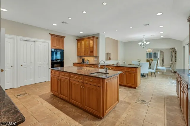 a large kitchen with stainless steel appliances granite countertop a large counter top and a stove
