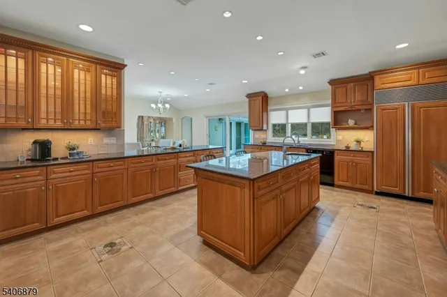 a kitchen with stainless steel appliances granite countertop a stove a sink dishwasher and a refrigerator