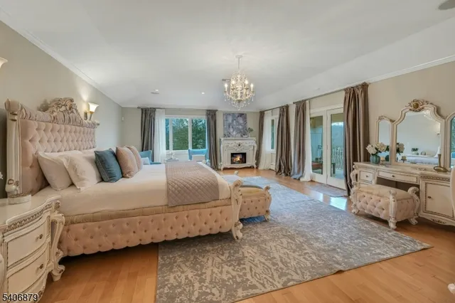 a spacious bedroom with a large bed and a chandelier