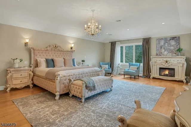 a spacious bedroom with a bed and a fireplace