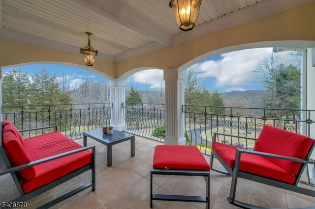 a view of a patio with a table chairs and a potted plant