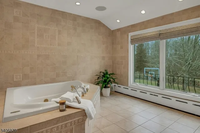 a bathroom with a tub and a large window
