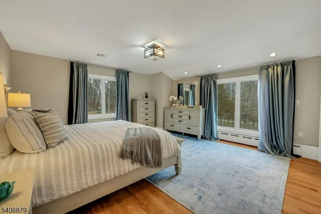 a bedroom with a large bed and a chandelier