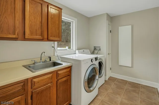 a utility room with sink dryer and washer