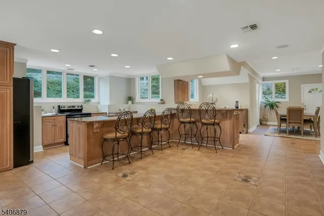 a open kitchen with lots of counter space and windows