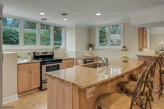 a kitchen with granite countertop lots of counter space and windows