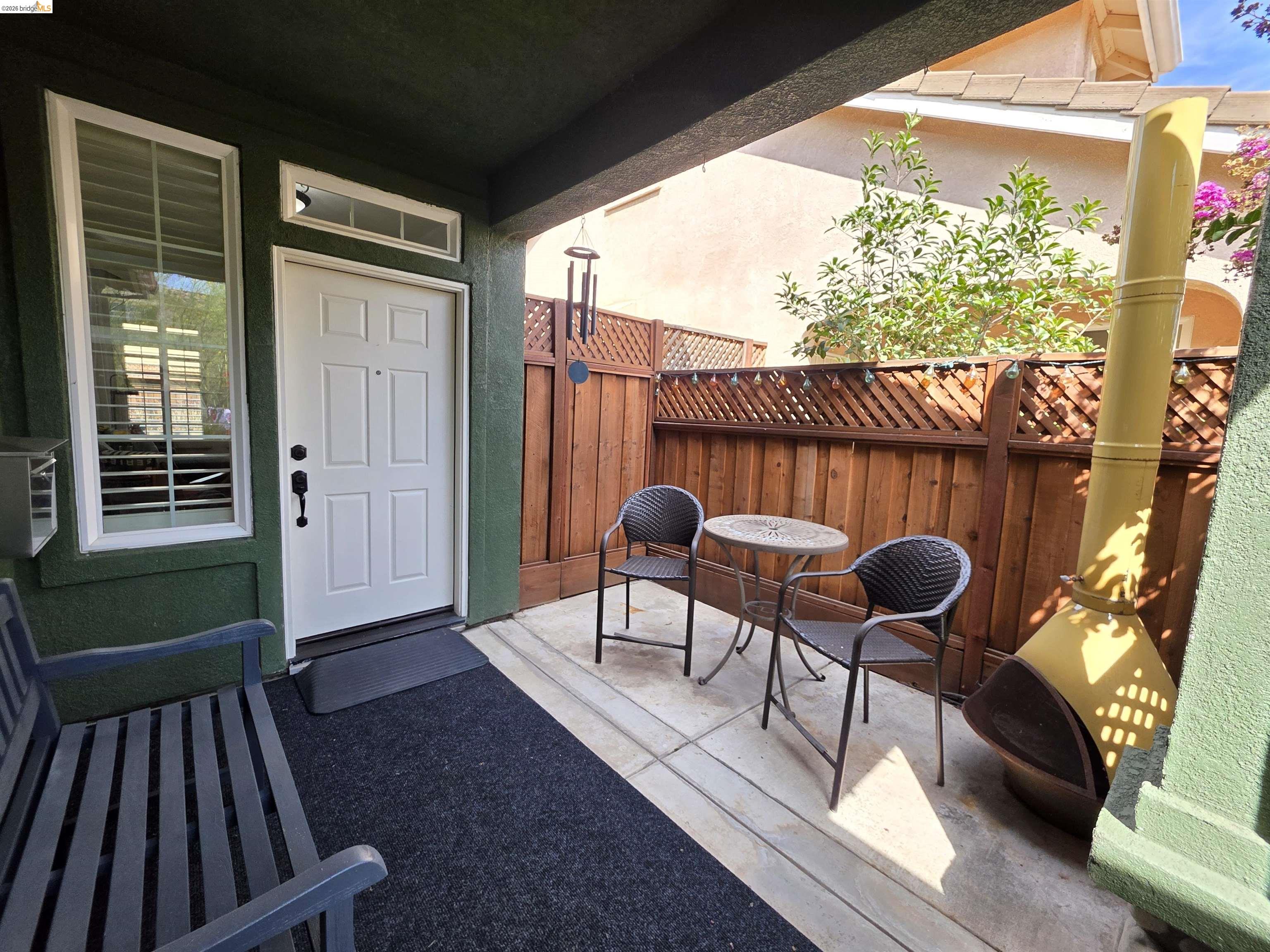 2607 Glow Road Riverbank, CA 95367 - Photo 4 of 42 Covered entry with a white paneled door, transom window, and a vertical window with louvered shutters
