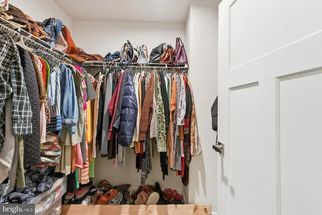 a view of walk in closet with clothes