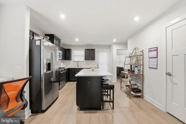 a kitchen with stainless steel appliances a refrigerator stove microwave and cabinets