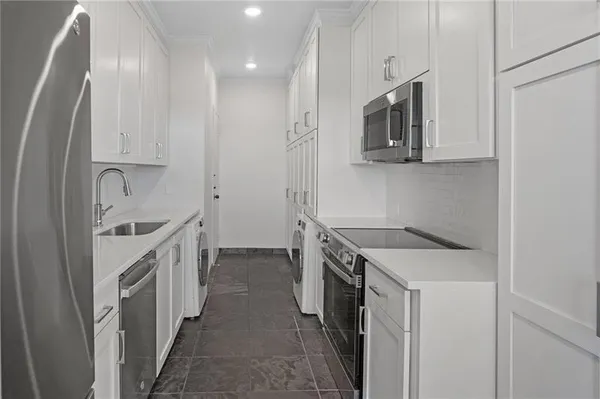a kitchen with a sink stove and refrigerator