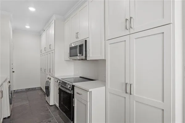 a kitchen with stainless steel appliances white cabinets and a sink