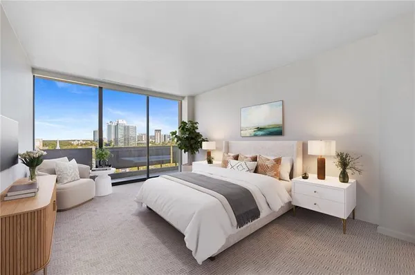 a bedroom with a bed and large window