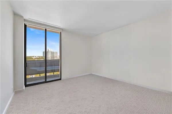 an empty room with sliding glass door