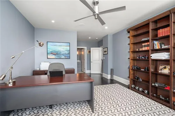 a living room with furniture and a book shelf