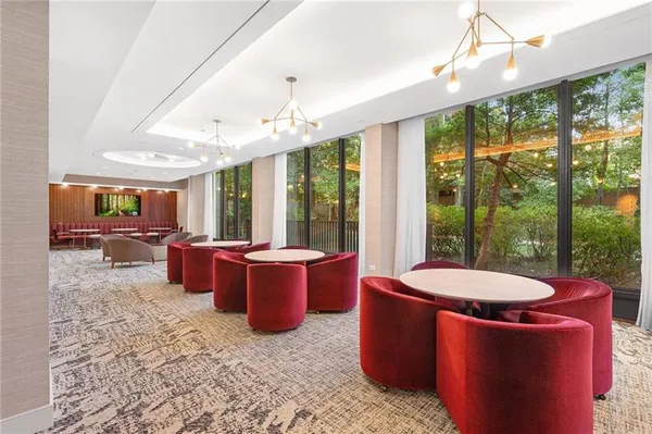 a living room with furniture and a floor to ceiling window