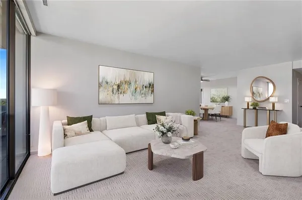 a living room with furniture a rug and a painting on the wall