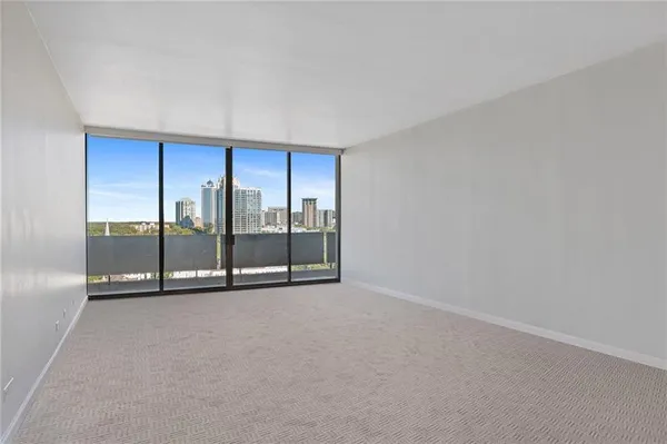 a view of an empty room with glass door