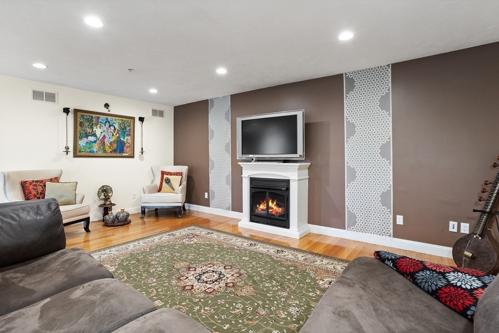 215 Rangeway Road, Unit 32 Billerica, MA 01862 - Photo 14 of 39 a living room with furniture flat screen tv and a fireplace