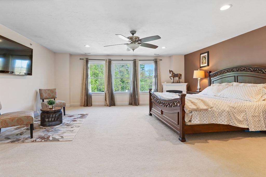 215 Rangeway Road, Unit 32 Billerica, MA 01862 - Photo 18 of 39 a bedroom with a bed and a chandelier