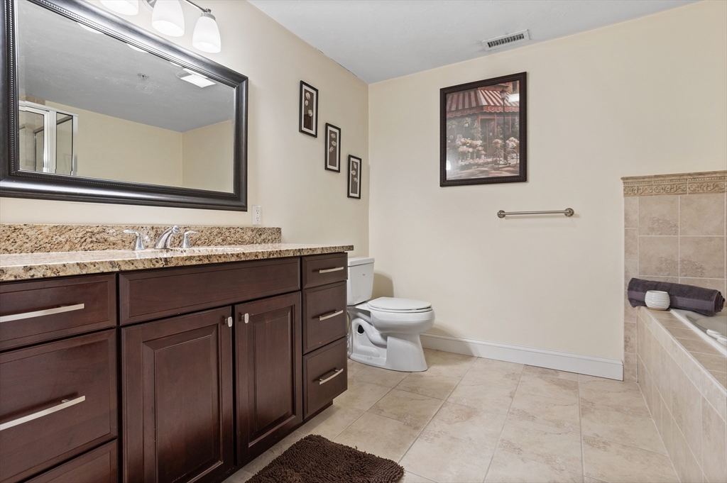 215 Rangeway Road, Unit 32 Billerica, MA 01862 - Photo 20 of 39 a bathroom with a sink a toilet and mirror