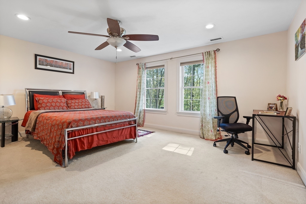 215 Rangeway Road, Unit 32 Billerica, MA 01862 - Photo 25 of 39 a bedroom with a bed a chair and a chandelier