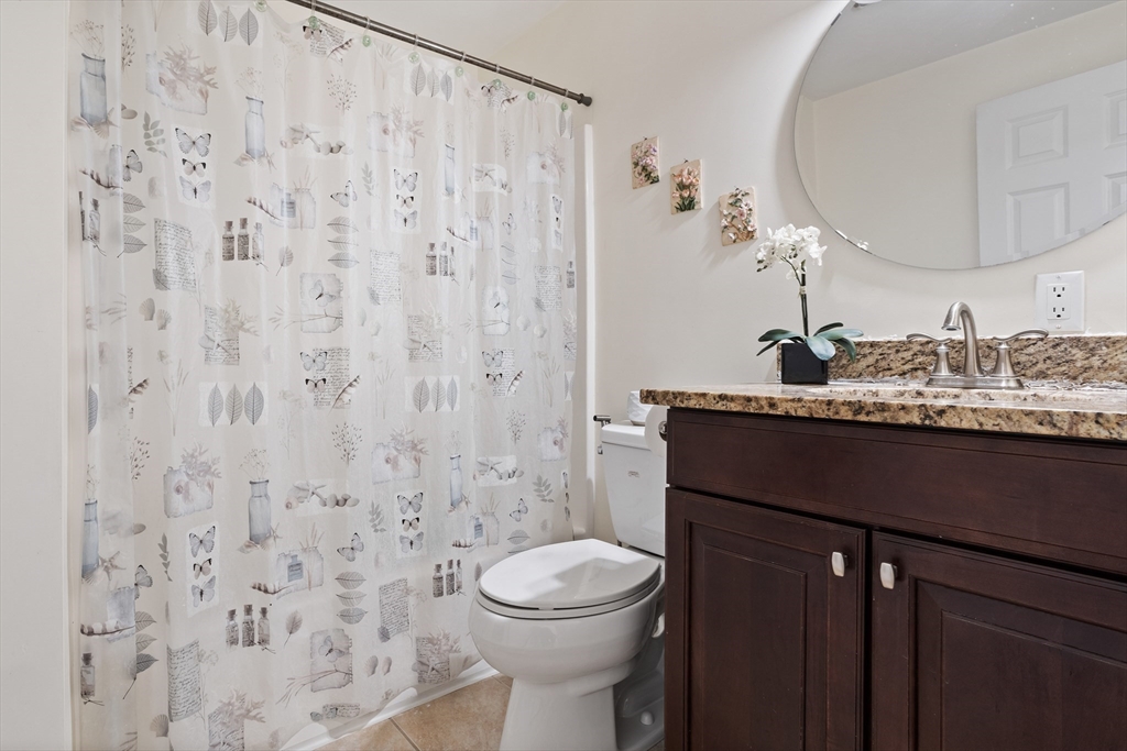 215 Rangeway Road, Unit 32 Billerica, MA 01862 - Photo 26 of 39 a bathroom with a sink a toilet and shower curtain