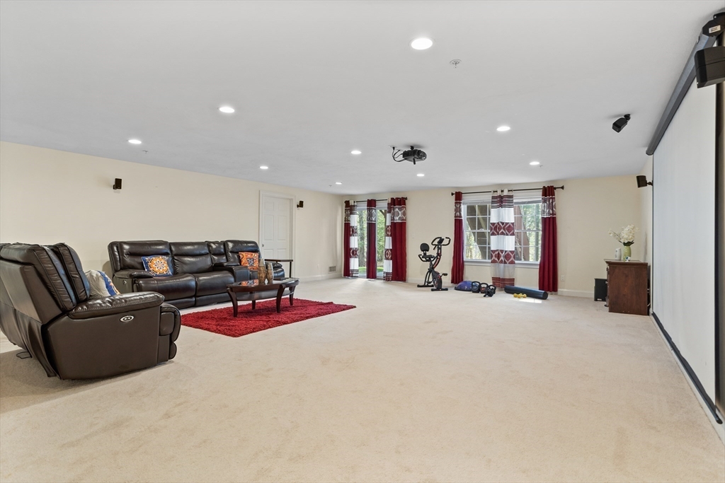 215 Rangeway Road, Unit 32 Billerica, MA 01862 - Photo 27 of 39 a living room with furniture and gym equipment