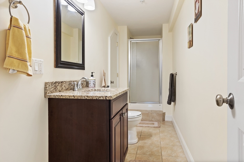 215 Rangeway Road, Unit 32 Billerica, MA 01862 - Photo 30 of 39 a bathroom with a granite countertop sink and a mirror
