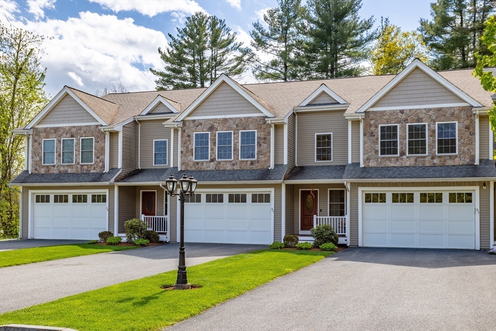 215 Rangeway Road, Unit 32 Billerica, MA 01862 - Photo 38 of 39 a front view of a house with a yard and garage