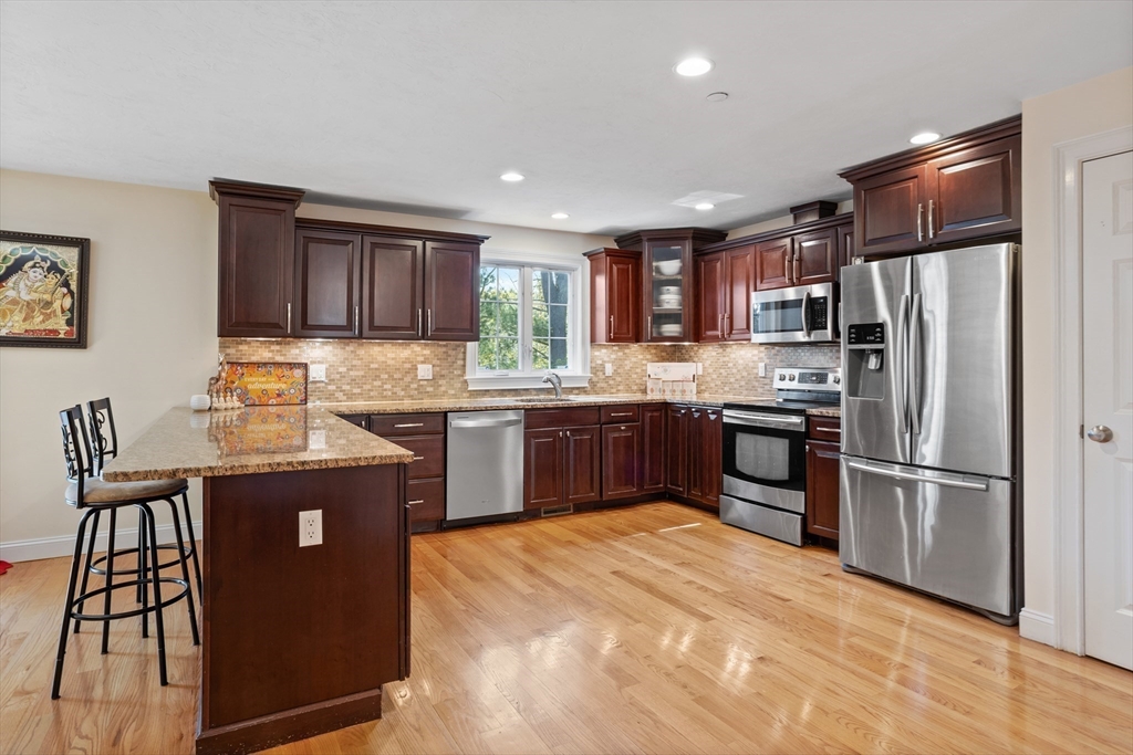 215 Rangeway Road, Unit 32 Billerica, MA 01862 - Photo 4 of 39 a kitchen with granite countertop a refrigerator stove top oven and sink