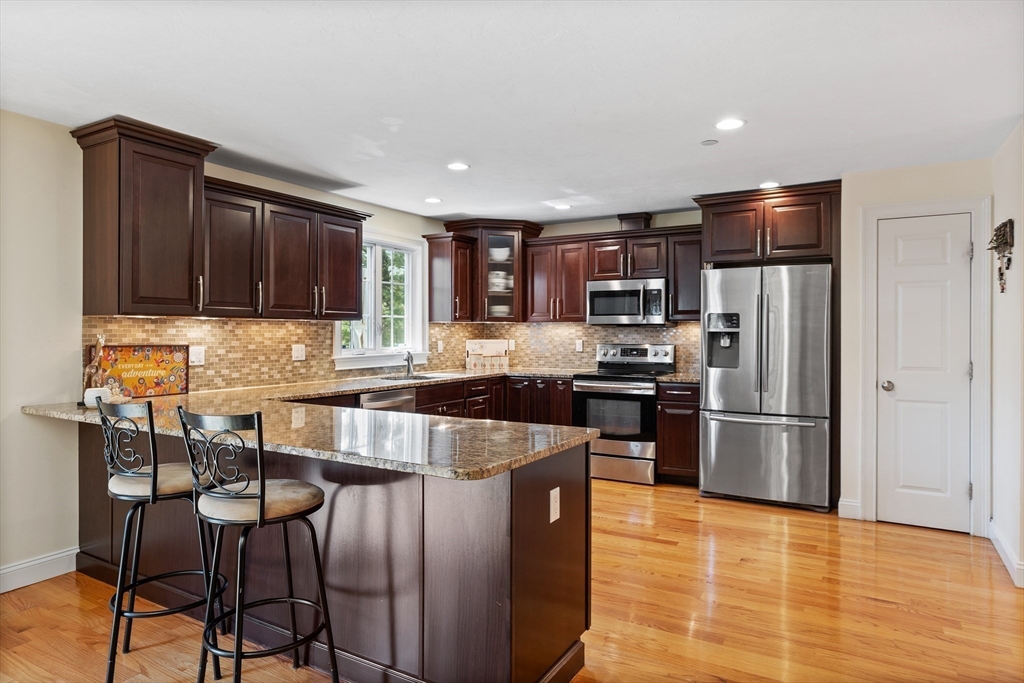 215 Rangeway Road, Unit 32 Billerica, MA 01862 - Photo 5 of 39 a kitchen with stainless steel appliances granite countertop a refrigerator stove microwave and sink