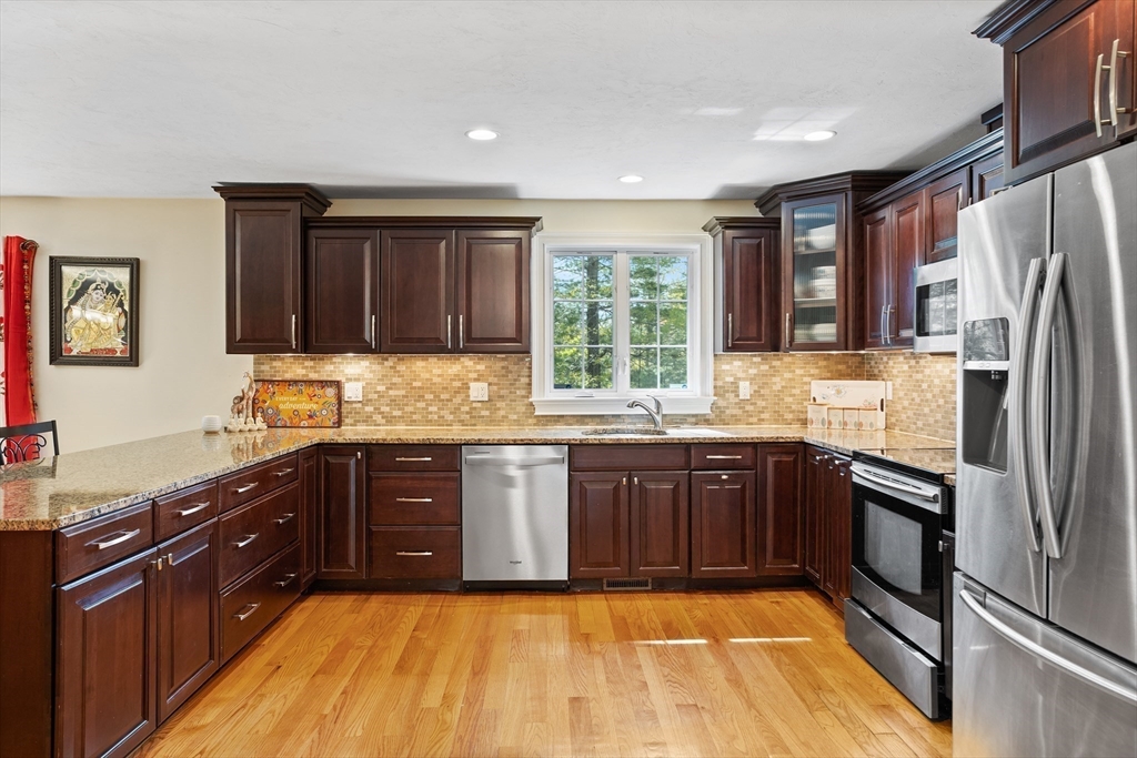 215 Rangeway Road, Unit 32 Billerica, MA 01862 - Photo 6 of 39 a large kitchen with granite countertop stainless steel appliances stove sink and cabinets