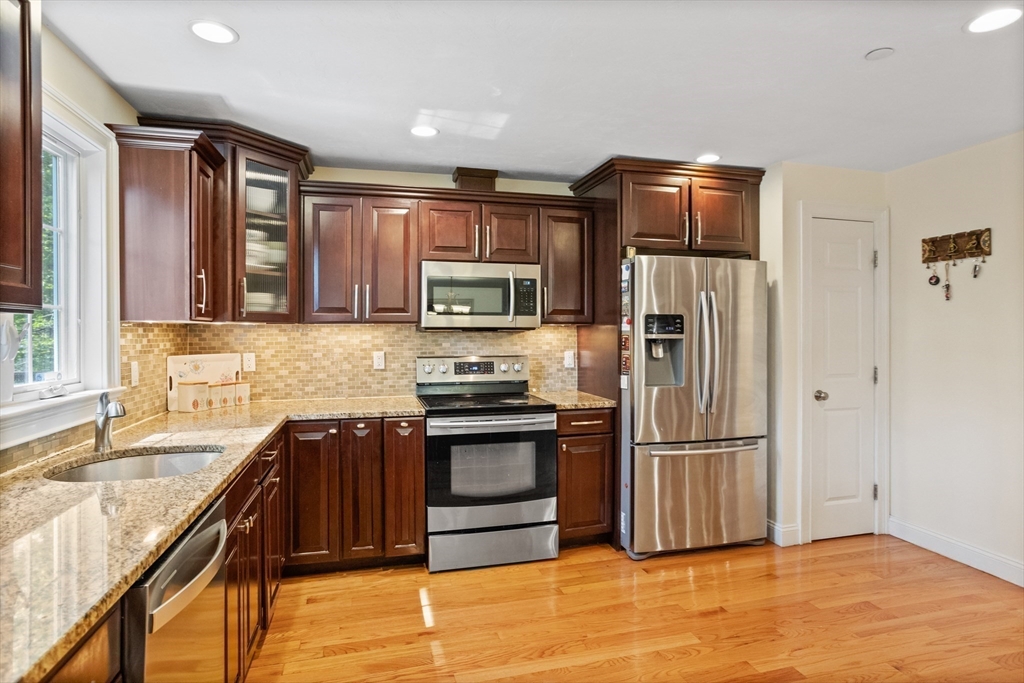 215 Rangeway Road, Unit 32 Billerica, MA 01862 - Photo 7 of 39 a kitchen with stainless steel appliances granite countertop a refrigerator stove and sink