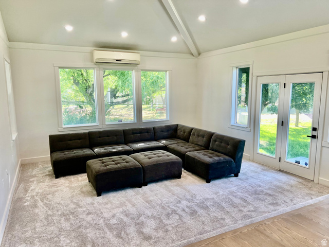 812 East Bates Cyn Road Tooele, UT 84074 - Photo 31 of 144 Spacious room featuring vaulted ceilings, recessed lighting, expansive windows, French doors, and new carpet flooring