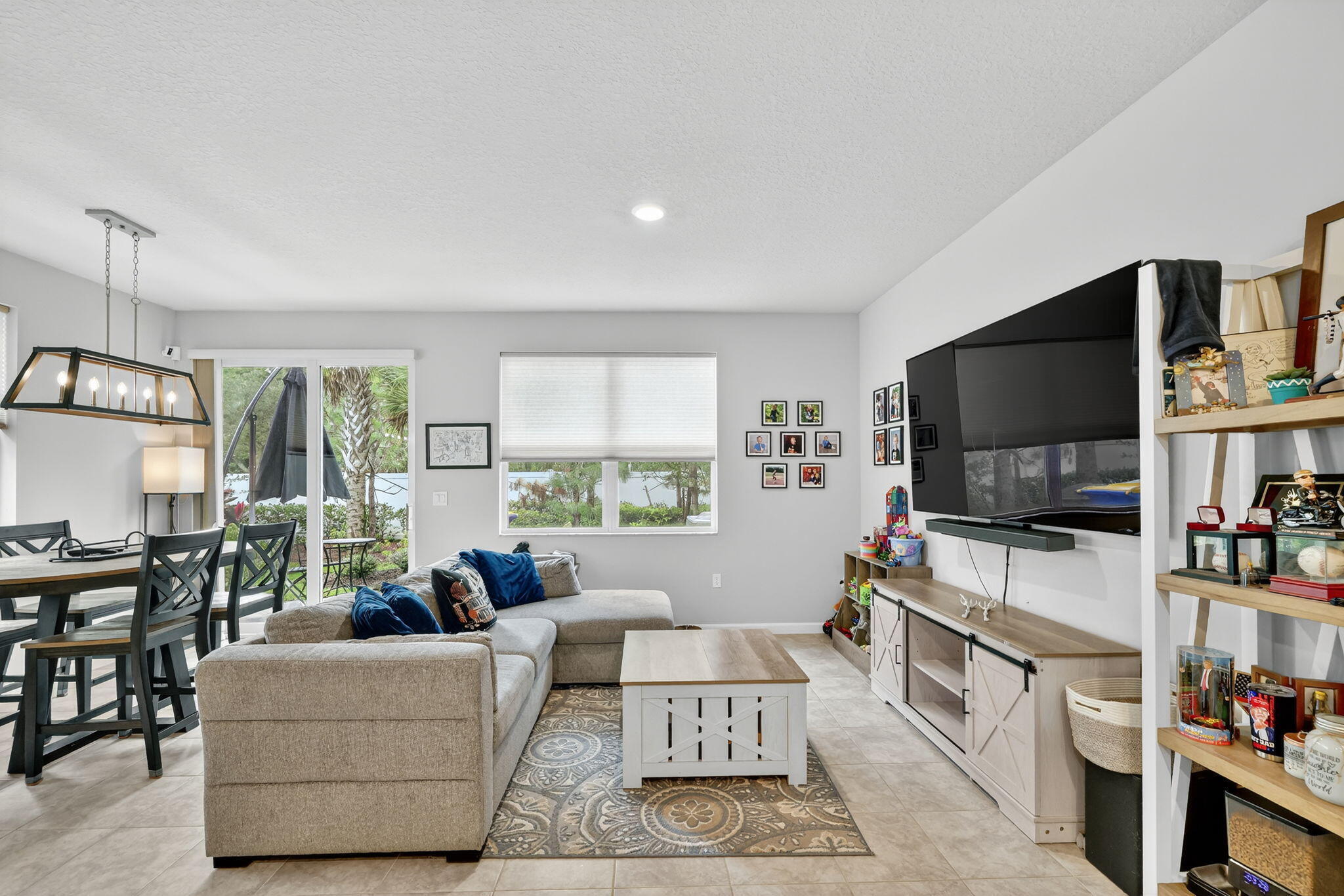 5672 Southeast Edgewater Circle Stuart, FL 34997 - Photo 11 of 26 a living room with furniture and a flat screen tv