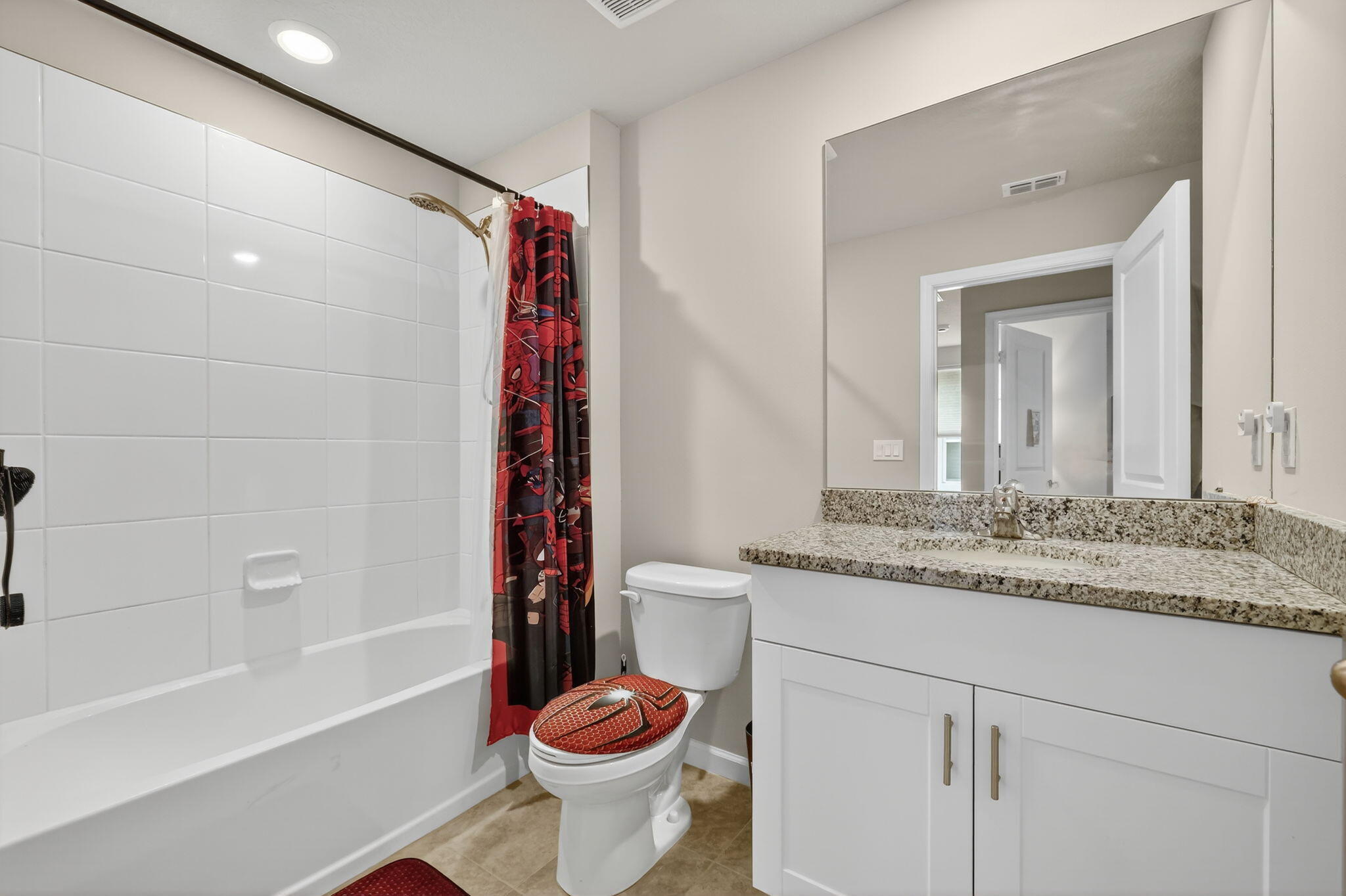 5672 Southeast Edgewater Circle Stuart, FL 34997 - Photo 20 of 26 a bathroom with a granite countertop sink and a mirror