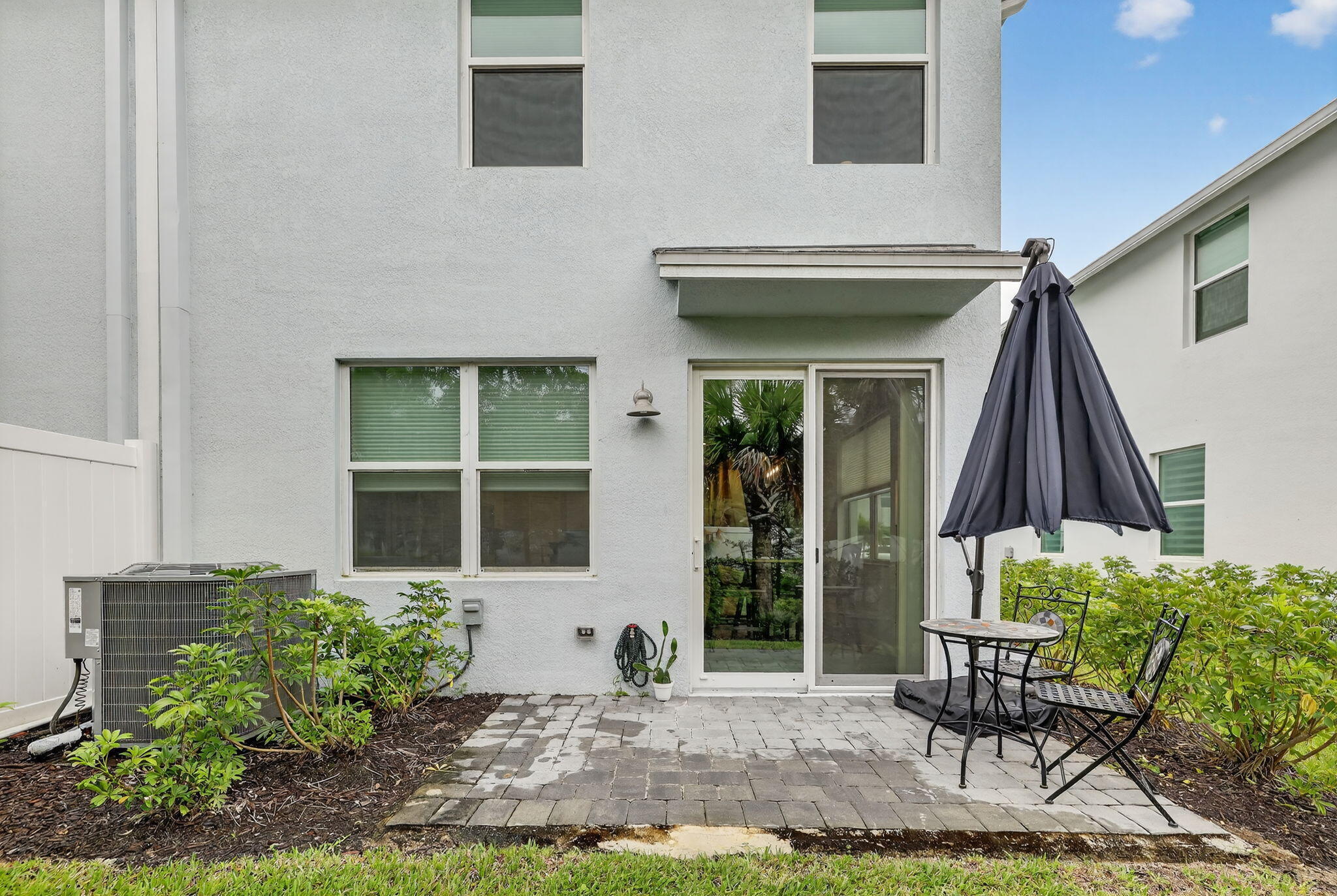 5672 Southeast Edgewater Circle Stuart, FL 34997 - Photo 25 of 26 a front view of a house with outdoor seating and plants