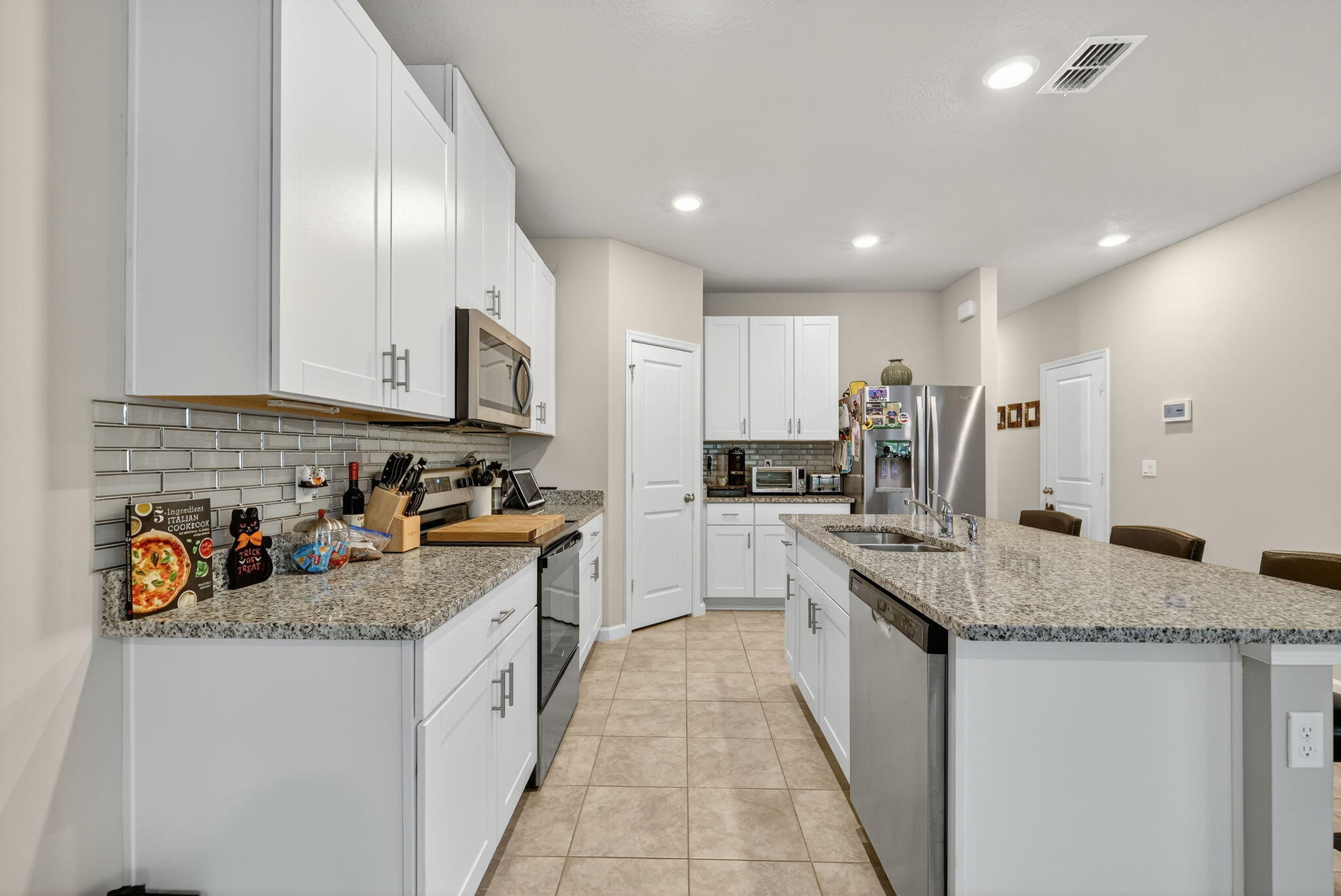 5672 Southeast Edgewater Circle Stuart, FL 34997 - Photo 4 of 26 a kitchen with stainless steel appliances granite countertop a sink stove and cabinets