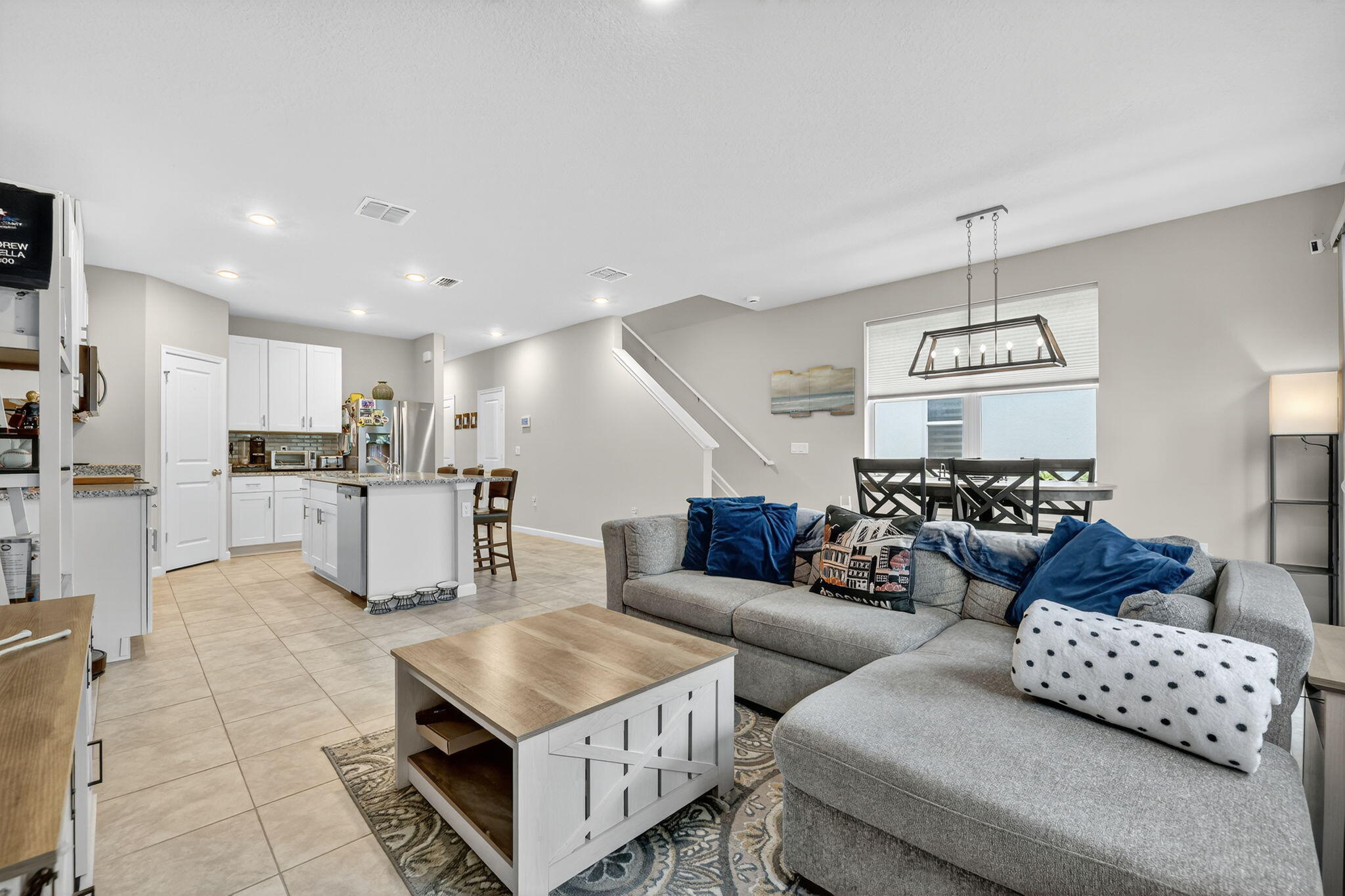5672 Southeast Edgewater Circle Stuart, FL 34997 - Photo 6 of 26 a living room with furniture and kitchen view
