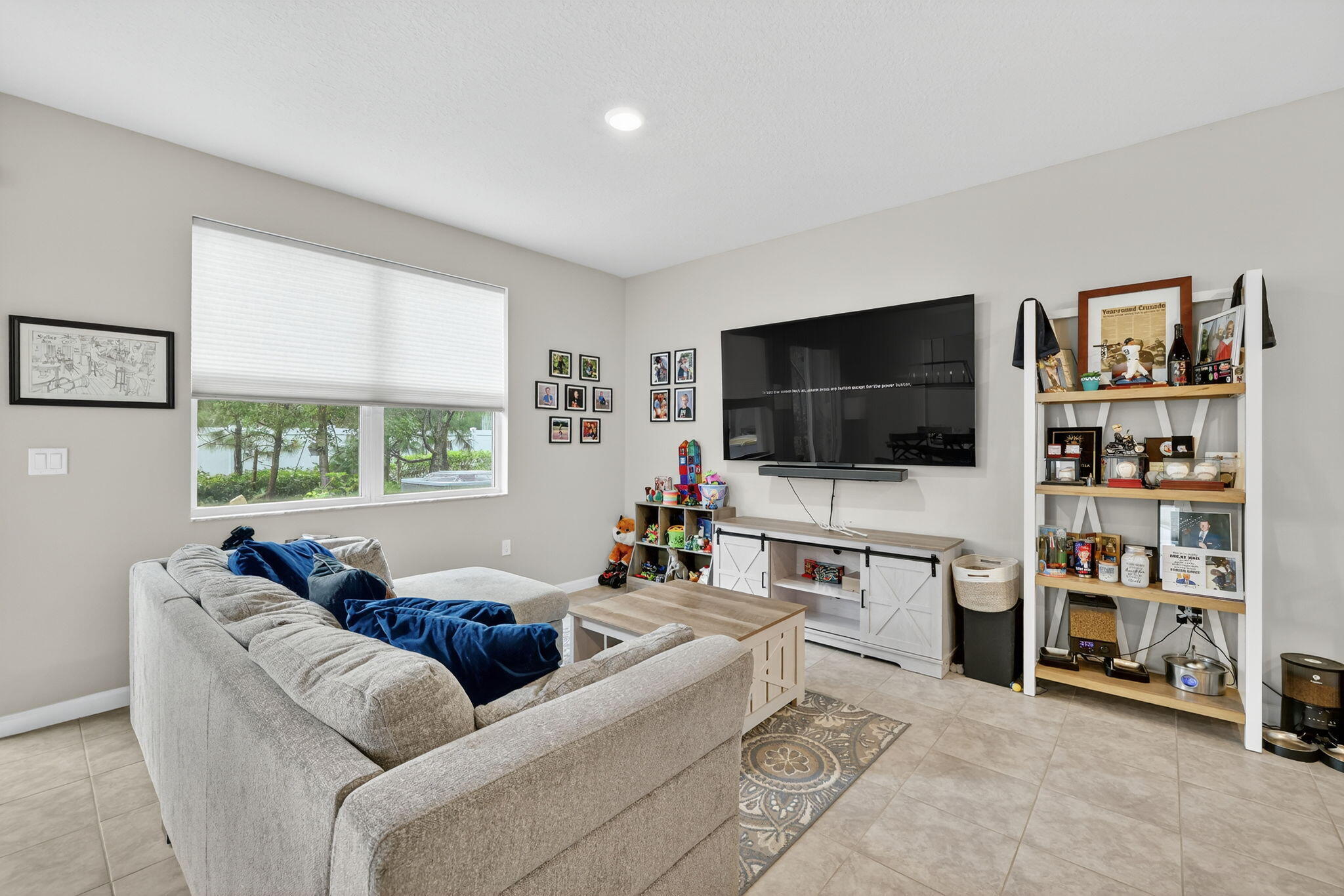 5672 Southeast Edgewater Circle Stuart, FL 34997 - Photo 7 of 26 a living room with furniture and a flat screen tv