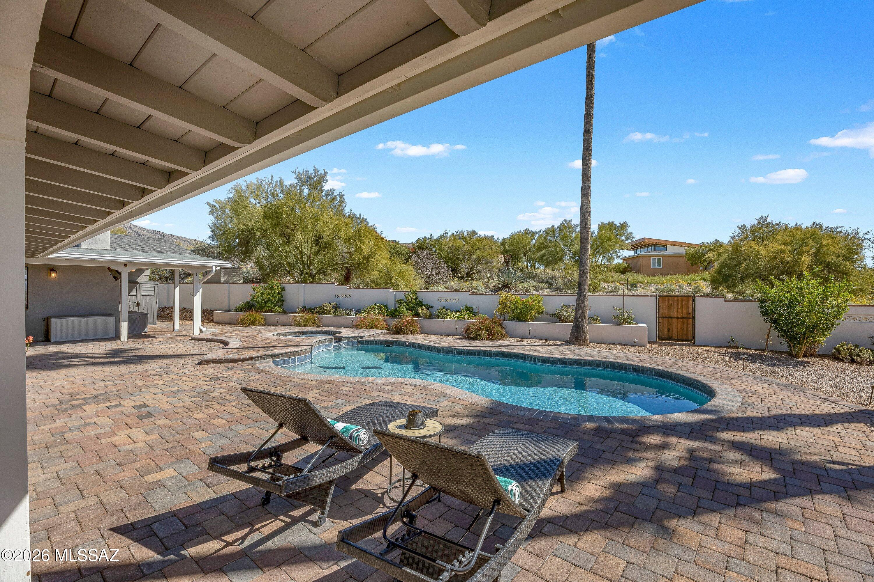 6020 North Swan Road Tucson, AZ 85718 - Photo 32 of 38 Outdoor TV area, fireplace, turf and views.