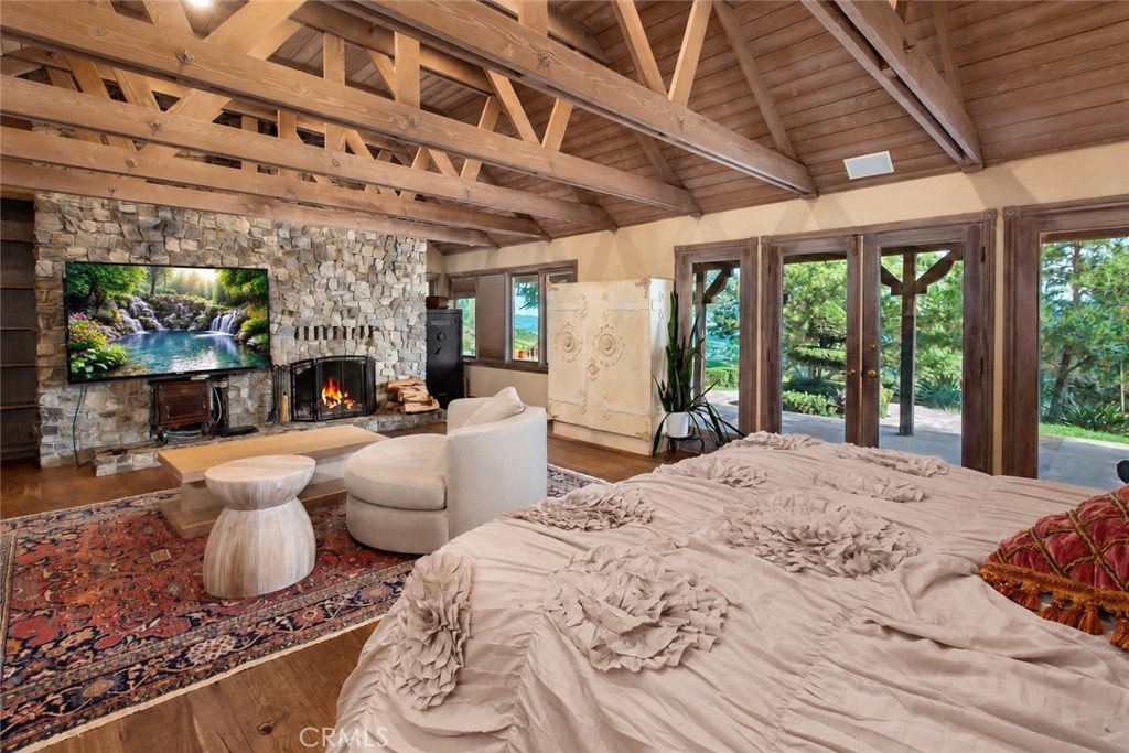27777 Sycamore Mesa Road Temecula, CA 92590 - Photo 30 of 72 Primary suite with exposed wood-beam ceiling, fireplace & direct access to outdoors