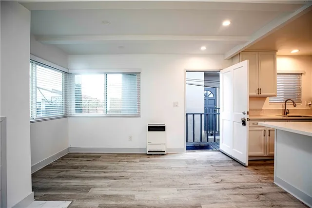 a view of a kitchen with a sink and dishwasher wooden floor