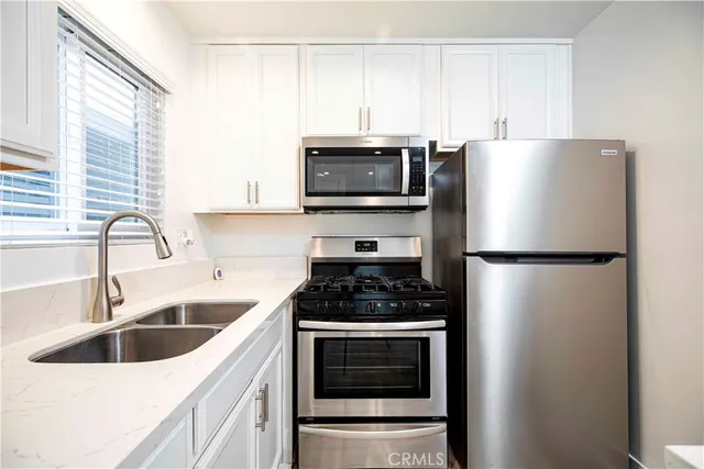 a kitchen with a refrigerator stove and sink