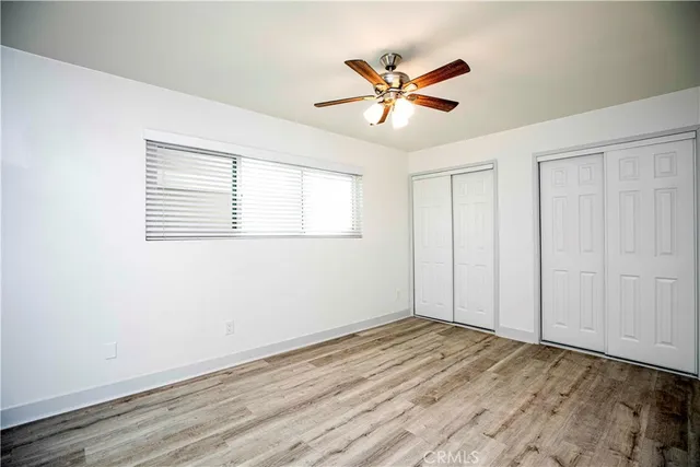 a view of a livingroom with wooden floor and a window
