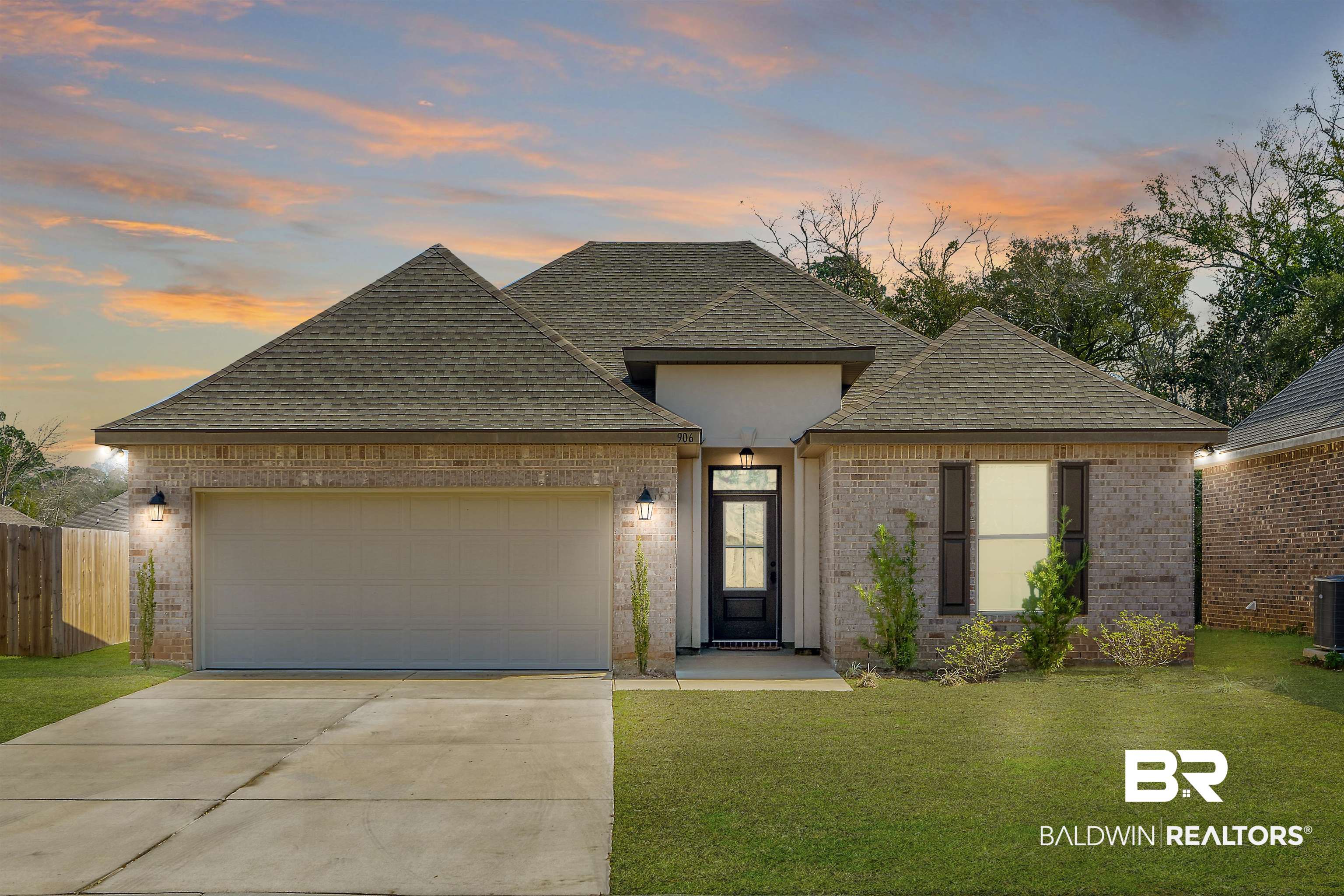 View of front of house featuring a yard and a garage